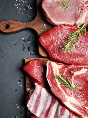 Flat lay composition with fresh meat on grey table. Space for text